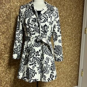 Spring coat with black and cream print, covered buttons and cuffed sleeves.